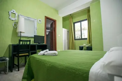 Letto o letti in una camera di Sant'Antonio Garden Rooms Apartments