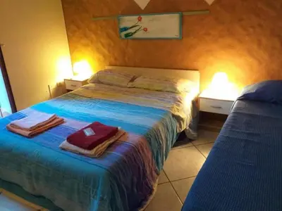 Letto o letti in una camera di Appartamento Ai piedi dell' Etna per gruppi fino a 20 persone