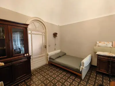 Letto o letti in una camera di RetroEtnea - Appartamento in centro storico - con camere comunicanti