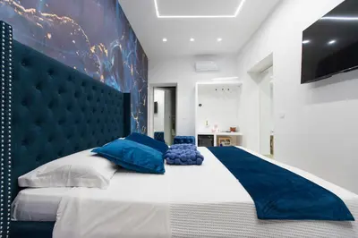 Letto o letti in una camera di 4 Rooms Rosario