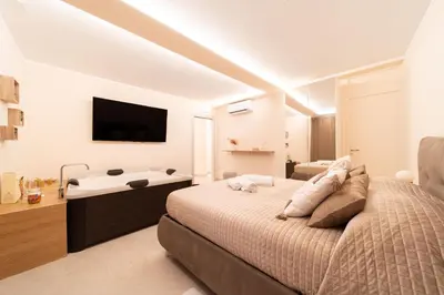 Letto o letti in una camera di Desiree Luxury House- vasca idromassaggio