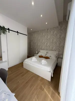 Letto o letti in una camera di Clemente house Catania centro CHIC