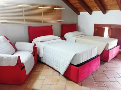 Letto o letti in una camera di Casa Happy - La mansarda del sorriso con parcheggio privato a Valcorrente