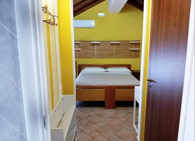 Letto o letti in una camera di Casa Happy - La mansarda del sorriso con parcheggio privato a Valcorrente