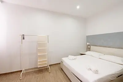 Letto o letti in una camera di Hermann Apartments