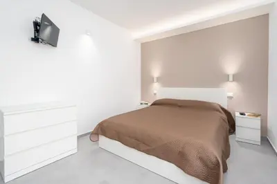 Letto o letti in una camera di GiuMar Apartments Acitrezza