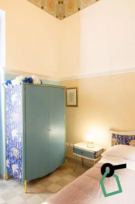 Letto o letti in una camera di Hotiday Catania Stanze Letterarie