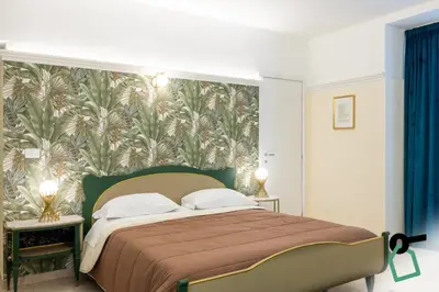 Letto o letti in una camera di Hotiday Catania Stanze Letterarie
