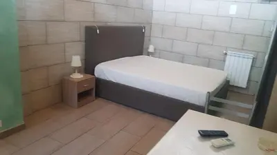 Letto o letti in una camera di B&B Mongibello