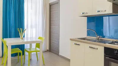 Cucina o angolo cottura di Residence Palazzo dei Delfini by RECEPTIO