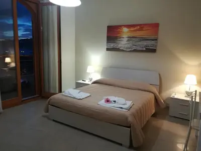 Letto o letti in una camera di B&B la spiaggetta di Stazzo
