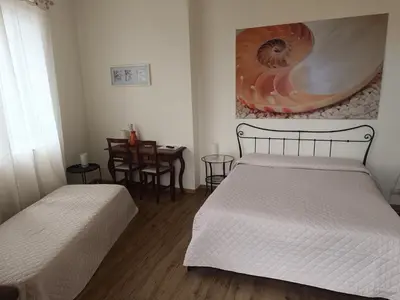 Letto o letti in una camera di B&B Stella Marina