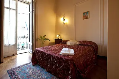 Letto o letti in una camera di B&B Alba