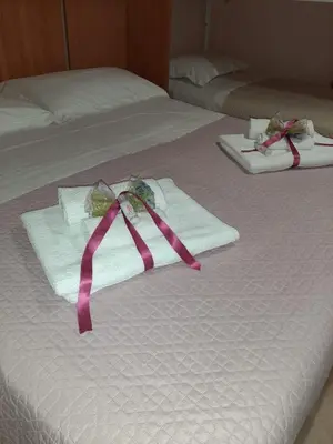Letto o letti in una camera di Casa vacanze ETNA COCUS
