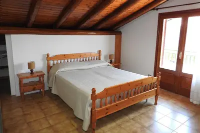 Letto o letti in una camera di Mansarda sul mare dei Ciclopi
