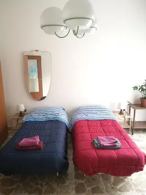 Letto o letti in una camera di At Claudio and Inna's Home