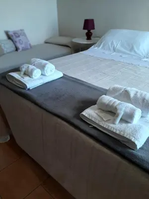 Letto o letti in una camera di Villa Etna Masi'