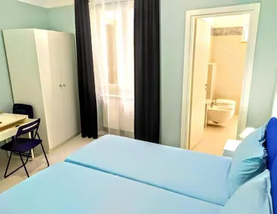 Letto o letti in una camera di Hello B&B
