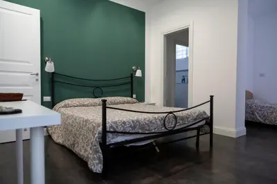 Letto o letti in una camera di B&B Giardino Bellini-centro