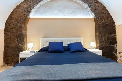 Letto o letti in una camera di GuestHost - Cerami Studio Flat