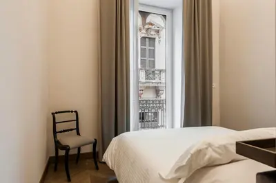 Letto o letti in una camera di Ferrini Home - Etnea Portrait