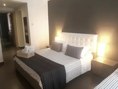 Letto o letti in una camera di Ottomood Ala Ovest Catania Centro
