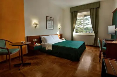 Letto o letti in una camera di Grande Albergo Maugeri