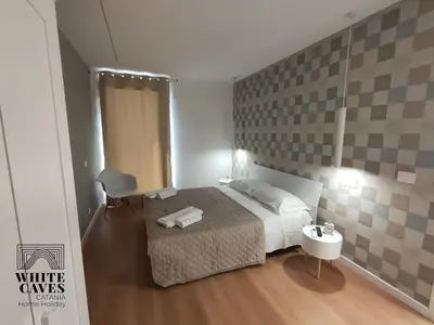 Letto o letti in una camera di white caves catania rooms