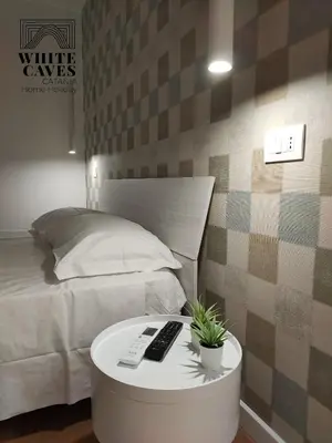 Letto o letti in una camera di white caves catania rooms