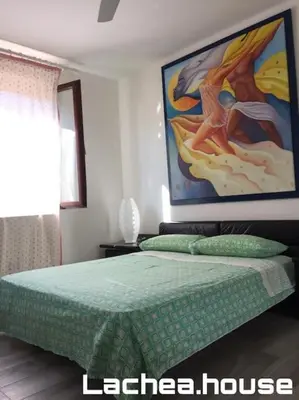 Letto o letti in una camera di Lachea House appartamento sul mare dei Ciclopi