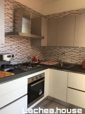 Cucina o angolo cottura di Lachea House appartamento sul mare dei Ciclopi