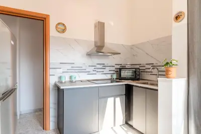 Cucina o angolo cottura di GuestHost - Parco Falcone Borsellino Cozy Apartment